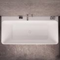 Top-down view of a modern white rectangular bathtub with a chrome faucet, set against dark gray marble-look tiled walls and floor.