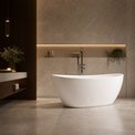 A modern freestanding oval bathtub in white, set in a luxurious bathroom with beige stone walls and floor, featuring a chrome faucet and built-in wood shelving.