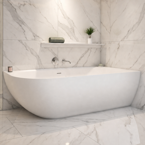 A modern freestanding bathtub in a bright marble-look bathroom with matching tiled walls and floor, a glass shower enclosure, and built-in shelving.