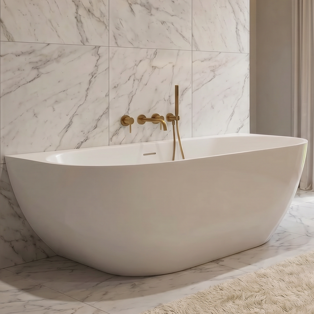 A luxury modern bathroom featuring a white freestanding bathtub set against a large white marble tiled wall, with a wooden vanity, illuminated mirror, and a soft beige rug on the floor.