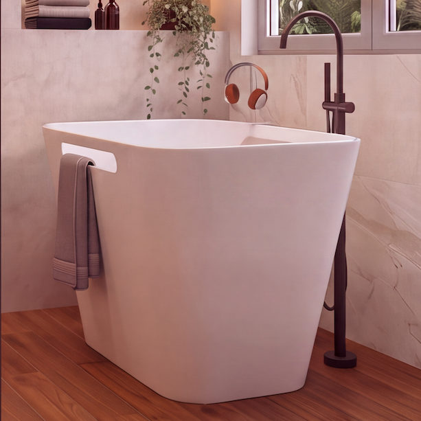 A modern luxury bathroom interior featuring a freestanding white bathtub in a glass-walled shower area, a white vessel sink on a floating vanity, a wall-mounted toilet, warm wood flooring, beige stone walls, and built-in shelving with plants and bottles.