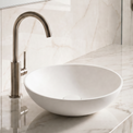 Bathroom sink with marble countertop and tiled wall