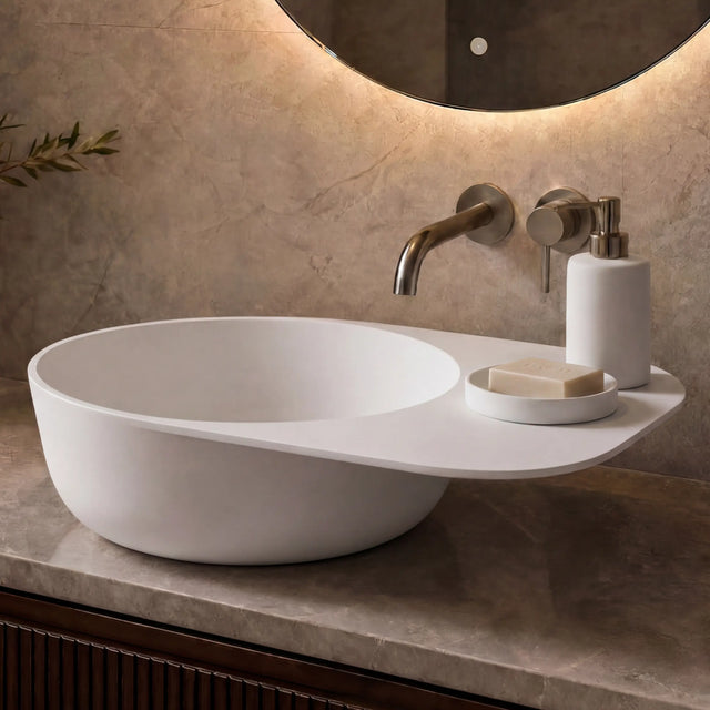 Modern bathroom vanity with a white sink, faucet, and decorative elements.