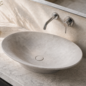 Bathroom vanity with a stone Concrete sink and modern faucet.