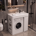 A white under-counter washing machine and dryer combo cabinet in a modern gray bathroom with a sink, toilet, and glass shower enclosure.