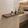 Bathroom counter with a wooden shelf holding skincare products against a tiled wall.