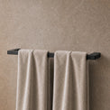 Towels hanging on a towel rack in a modern bathroom.