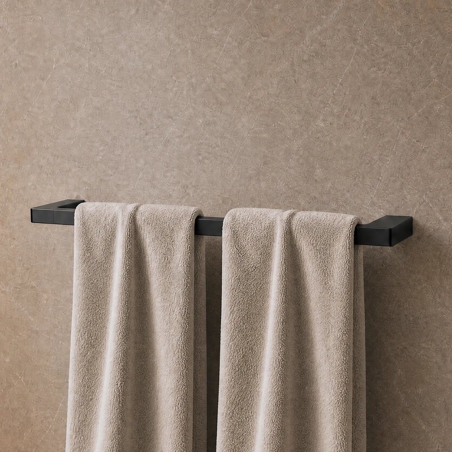 Towels hanging on a towel rack in a modern bathroom.