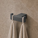 Towel rack with towels on a textured wall in a bathroom setting