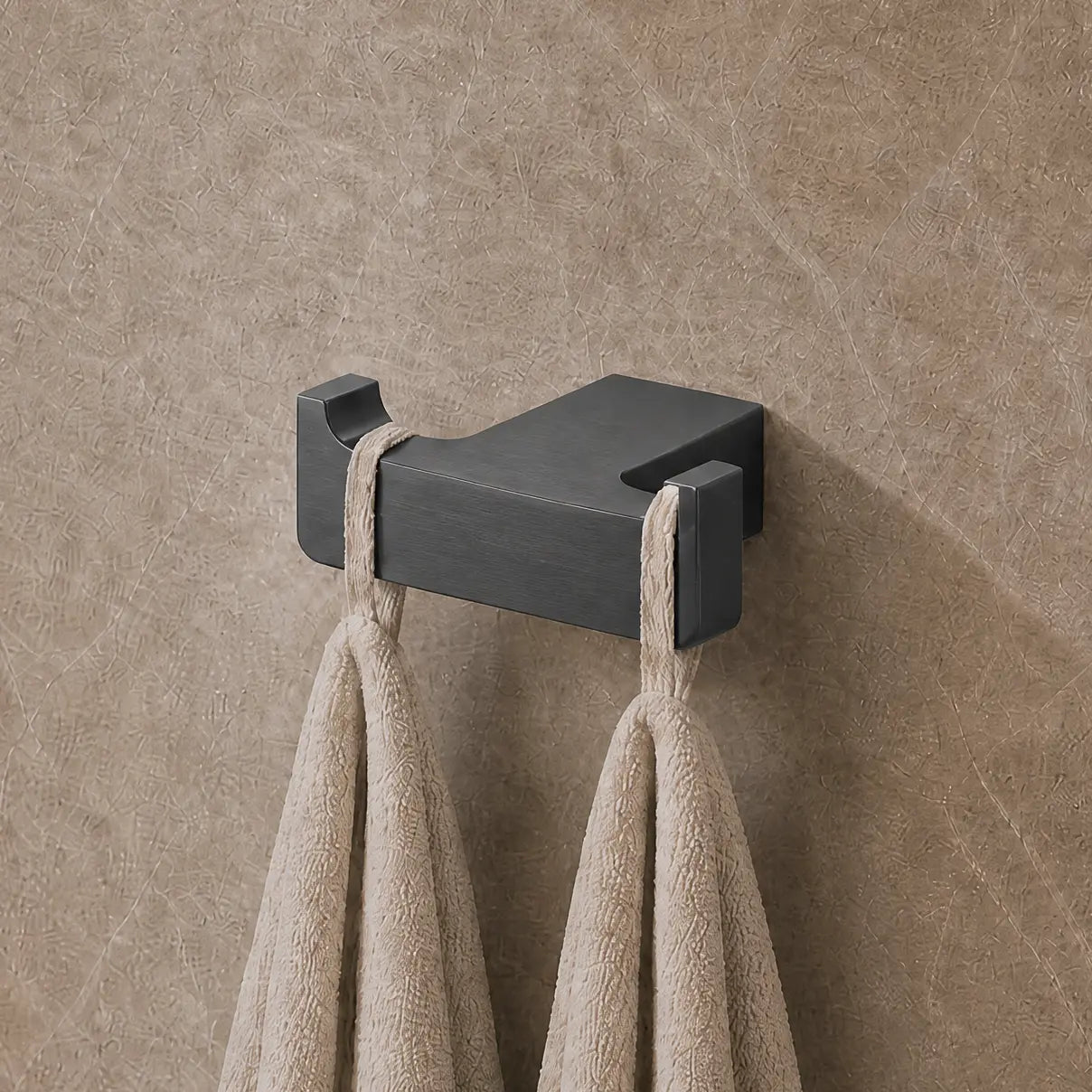 Towel rack with towels on a textured wall in a bathroom setting
