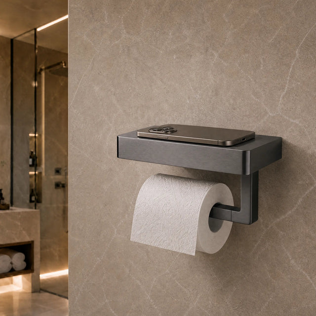 Modern black toilet paper holder with a roll of toilet paper on a beige tiled bathroom wall.