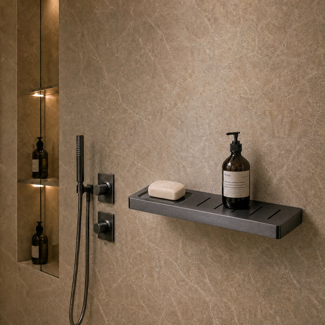 Modern bathroom with shower setup and toiletries on a shelf.