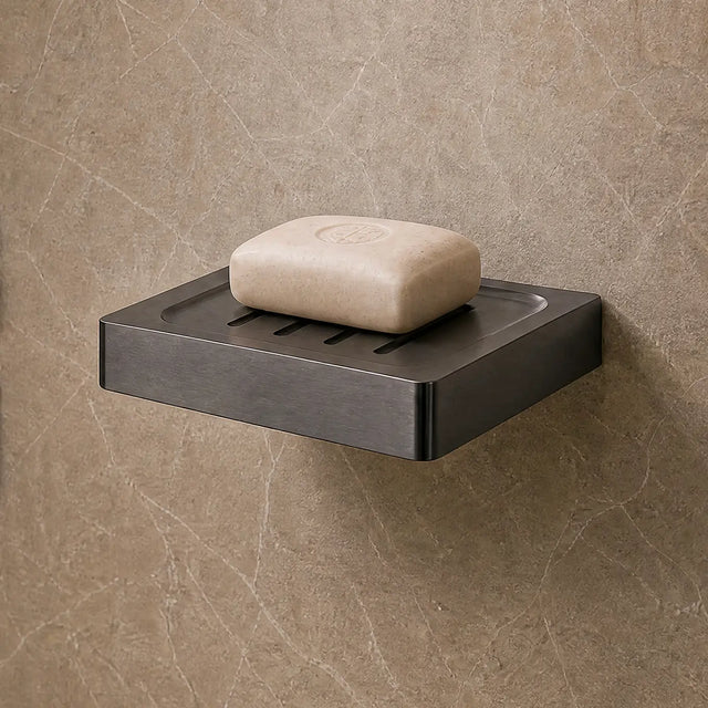 Modern bathroom shower area with soap dish and toiletries.