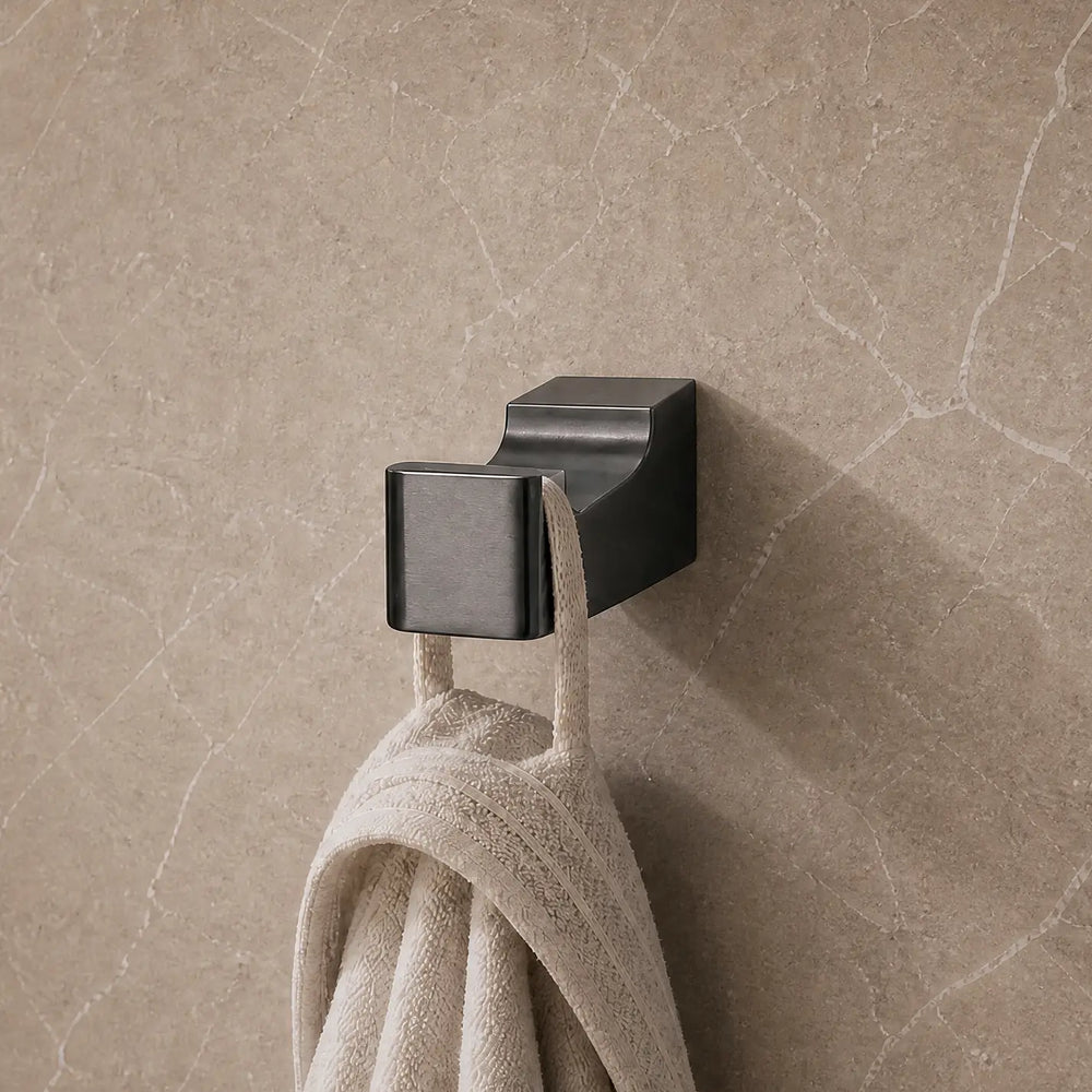 Towel hanging on a hook in a modern bathroom with neutral tones.