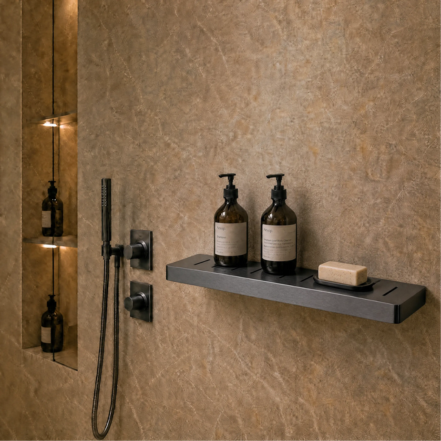 Bathroom with shower setup, bottles on a shelf, and mirror reflecting the room.