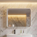 Bathroom vanity with mirror against a marble wall