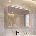 Modern bathroom with marble walls, a white vanity, and a large mirror.